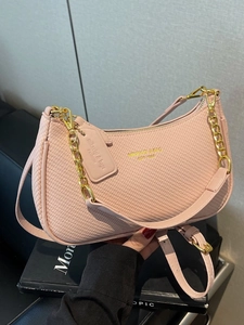 Pink half-moon crossbody bag with woven texture and gold chain strap handle