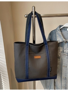 Charcoal canvas tote bag with deep blue straps and a spacious front pocket