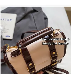Dettaglio della borsa a cilindro retrò con rivetti dorati e tracolla in metallo regolabile