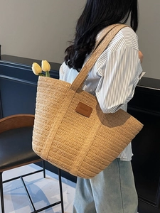 Large capacity woven straw tote bag with shoulder straps and brown leather patch