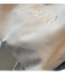 Detail view of ODBAO letter embroidery on durable high-density canvas tote bag