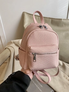 Pink herringbone mini backpack with adjustable leather straps and main zipper pocket