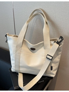 Large capacity off-white canvas tote bag with adjustable shoulder strap and side pockets