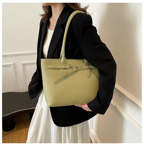 Détail du cabas en cuir vert clair avec texture grainée et boucle argentée réglable
