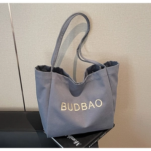 Close-up of gray canvas tote bag showing the high-density texture and BUDBAO embroidery