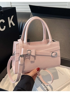 Pink handheld bag with bow detail and adjustable shoulder strap for women fashion