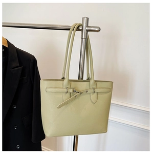 Détail du sac cabas vert clair avec cuir texture litchi et boucle décorative