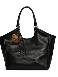 Black leather tote bag with large capacity featuring a cute plush bear charm accessory