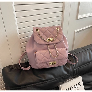 Detail of lilac quilted backpack featuring gold-tone turn-locks and leather chain straps