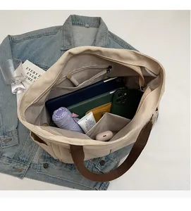 Top view of spacious beige canvas tote bag showing internal pockets and large capacity