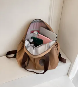 Detail view of khaki travel backpack interior showing multiple storage compartments