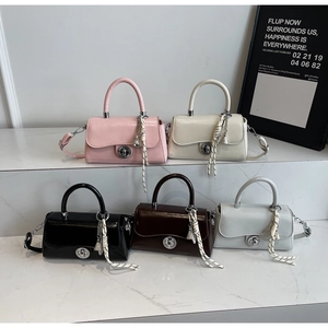 Five assorted colors of crossbody square bags with metal turn-lock and tassel detail