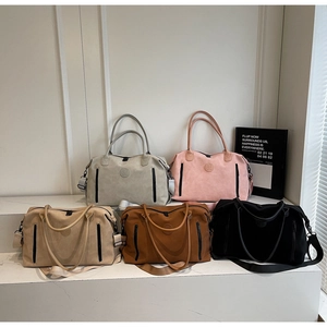 Detailed display of multi-color travel duffel bags with wide straps and side zip pockets
