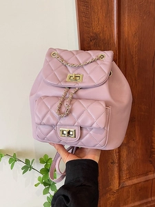 Pink quilted backpack with golden chain straps and metallic twist lock for women