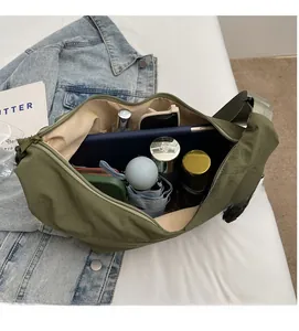 Interior view showing the large capacity of the army green nylon crossbody bag with essentials