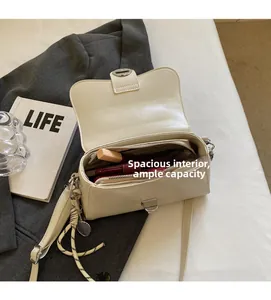 Detail of cream PU crossbody bag interior showing spacious storage for daily essentials