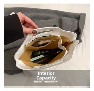 Top view of white tote bag interior with yellow lining showing spacious capacity