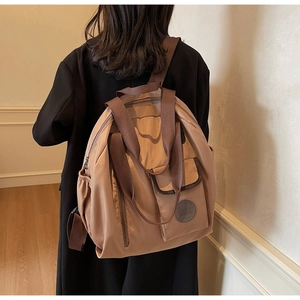 Modern khaki oxford backpack on model, featuring large capacity and stylish casual design