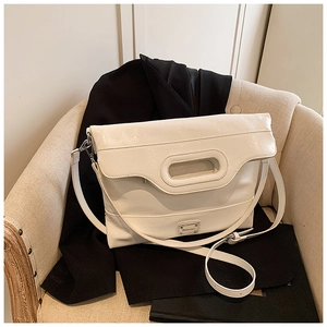 Detailed macro view of cream-white bucket bag with vintage wrinkled leather texture