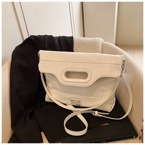 Detail of off-white leather bucket bag featuring silver logo plate and hollow handle ring