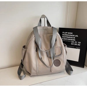 Detail of grey Oxford fabric backpack with side pockets and stylish SO&N logo patch