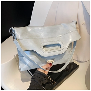 Detail of light blue faux leather bucket bag with retro wrinkled texture and metal logo
