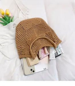 Detail of a brown hand-knitted tote bag showing spacious storage for daily essentials