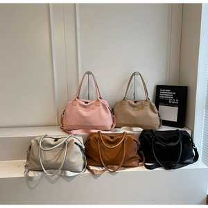 Detailed view of large travel tote bags in five matte colors with wide shoulder straps