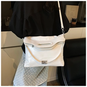 White pleated leather shoulder bag with top handle cutout and adjustable strap