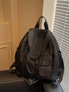 Large black Oxford fabric backpack for women, stylish travel bag with water-resistant finish