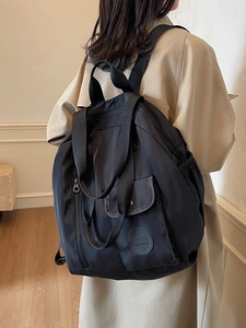 Large black nylon backpack for women with multifunctional pockets for travel and commute