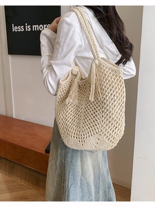 Bohemian off-white woven crochet tote bag with fringe tassels and shoulder straps
