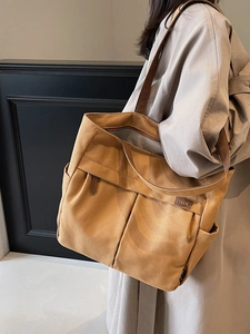 Retro tan canvas tote bag with large pockets and spacious design for daily commute