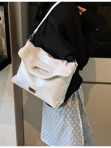 White oily faux leather bucket bag with top handle and adjustable shoulder strap