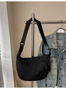 Minimalist black nylon crescent crossbody bag with wide adjustable shoulder strap