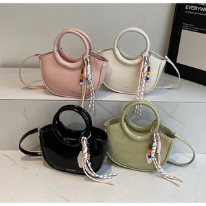 Fashionable mini bucket bags in pink, white, black, and green with beaded tassels