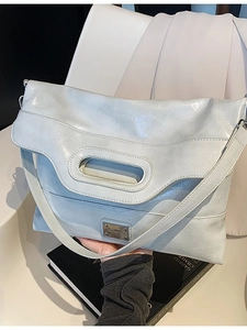 Modern light blue pleated PU leather bucket bag with cut-out handle and metal plaque