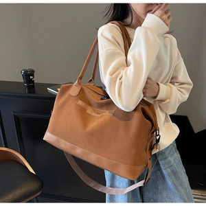 Détail de ce grand sac cabas marron montrant la texture mate et le logo NINGJIA