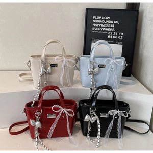Chic bucket bags in four colors with decorative lace bows and metallic butterfly charms