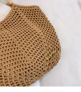 Close-up of dark brown woven tote bag showing detailed hollow mesh texture and rope fiber