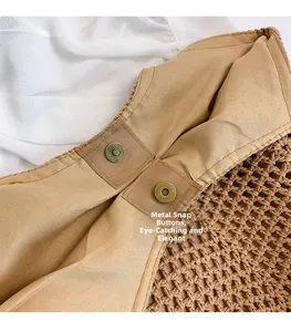 Macro detail of high-quality magnetic metal buckle on a woven hollow shoulder bag