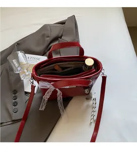 Detail view of red oil wax leather bucket bag with spacious interior compartments and pockets
