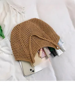 Detail showing high-capacity interior of brown woven tote bag with daily essentials