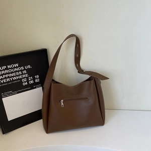 Detailed back view of brown hobo bag showing adjustable strap and zipper pocket