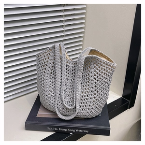 Close-up of grey crochet hollow-out pattern on woven tote bag with soft inner lining
