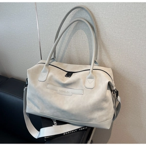 Vue détaillée du sac de voyage gris avec plaque logo NINGJIA et texture mate