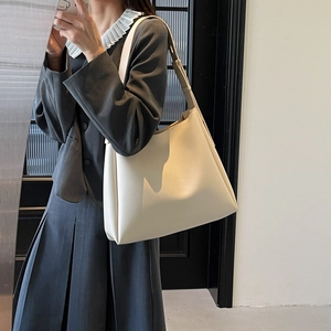 Detail view of cream white minimalist tote bag with adjustable wide shoulder strap