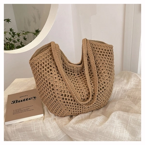 Close-up of woven straw tote bag featuring hollow mesh texture and fabric lining