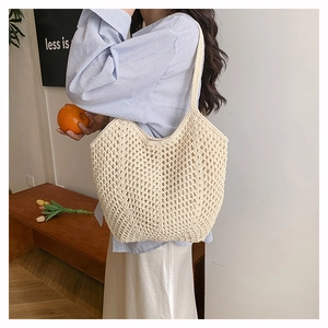 Detail of cream woven crochet shoulder bag featuring hollow diamond mesh pattern