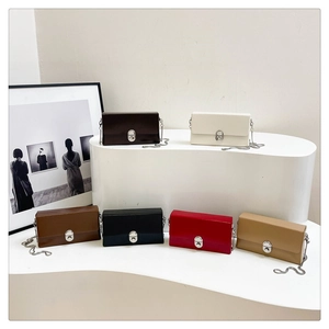 Detail view of stylish small square crossbody bags with chain straps in six diverse colors